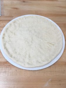 PIZZA DOUGH EXTENDED ON A DISK