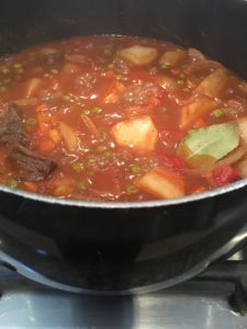 beef stew adding peas and bay leave